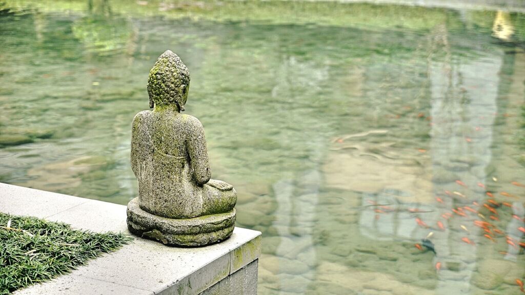 Meditierende Buddha Statue am Teich.